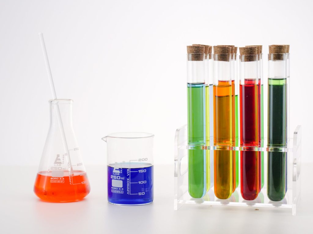 Laboratory glassware containing colorful liquids