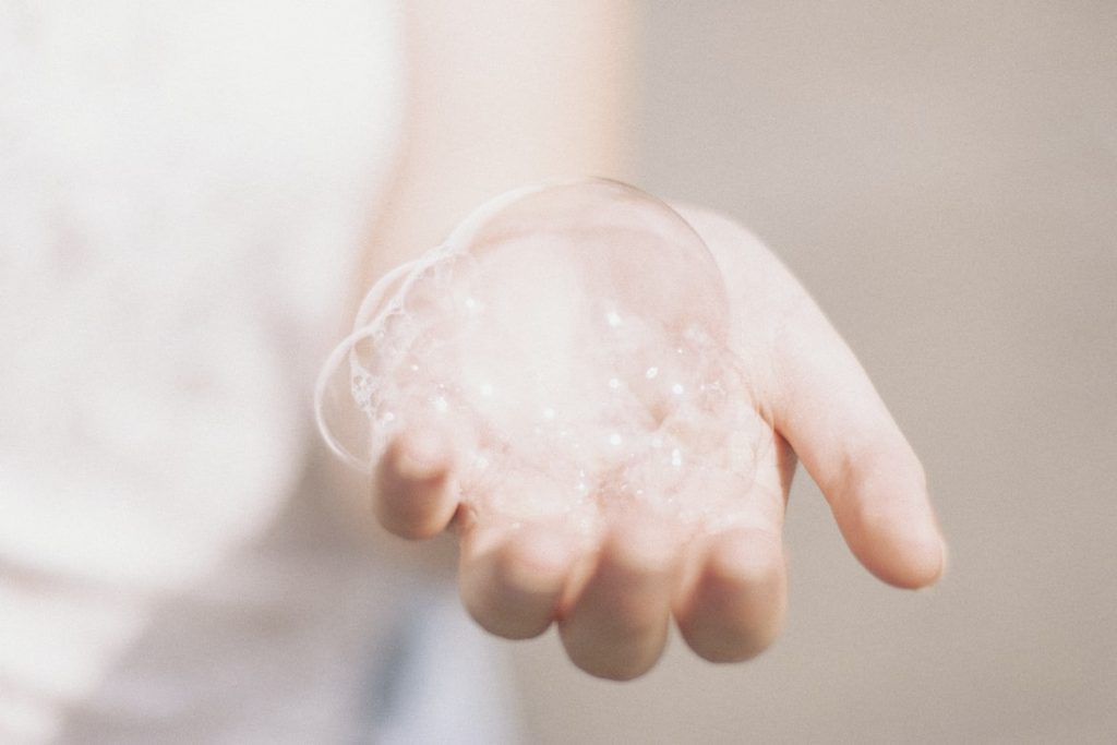 A person holding bubbles in their hand