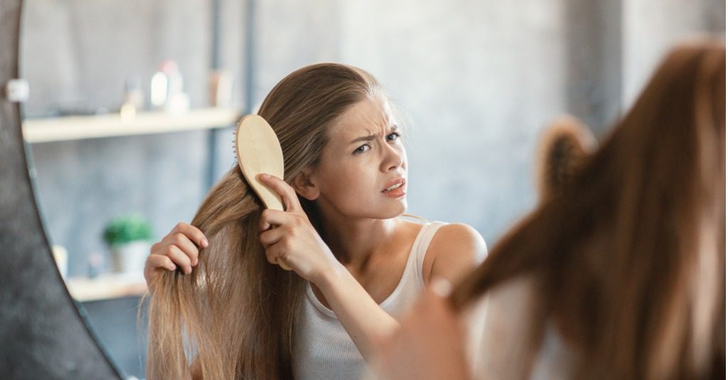 A young woman brushing her hair