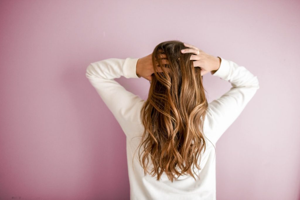 A woman touching her hair