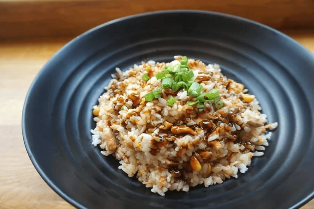 Brown rice on a black ceramic plate