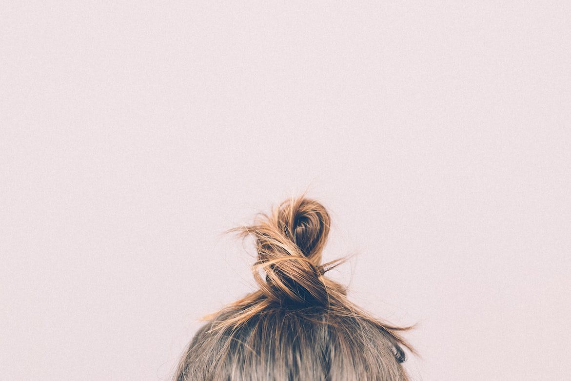 Girl’s hair put up into a messy bun