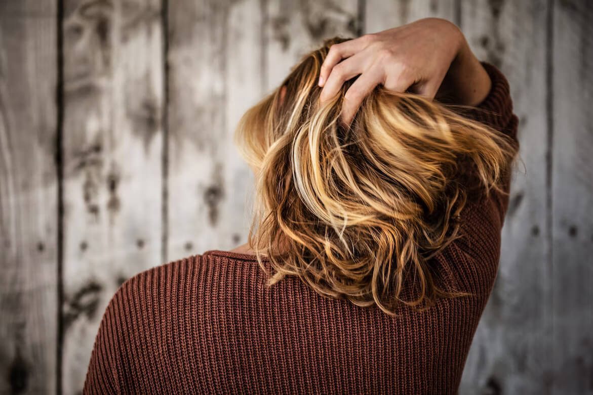 A woman touching her hair