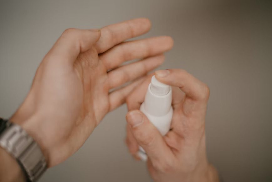A man applying serum to his hand