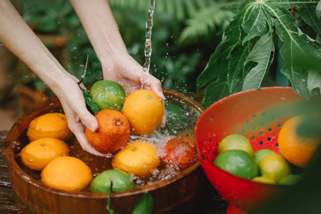 A woman washing fruits