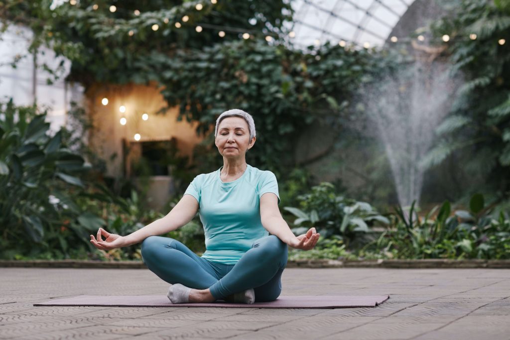 A woman meditating outdoors