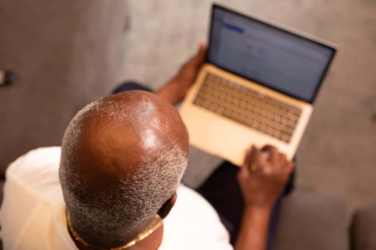 Balding man using his laptop